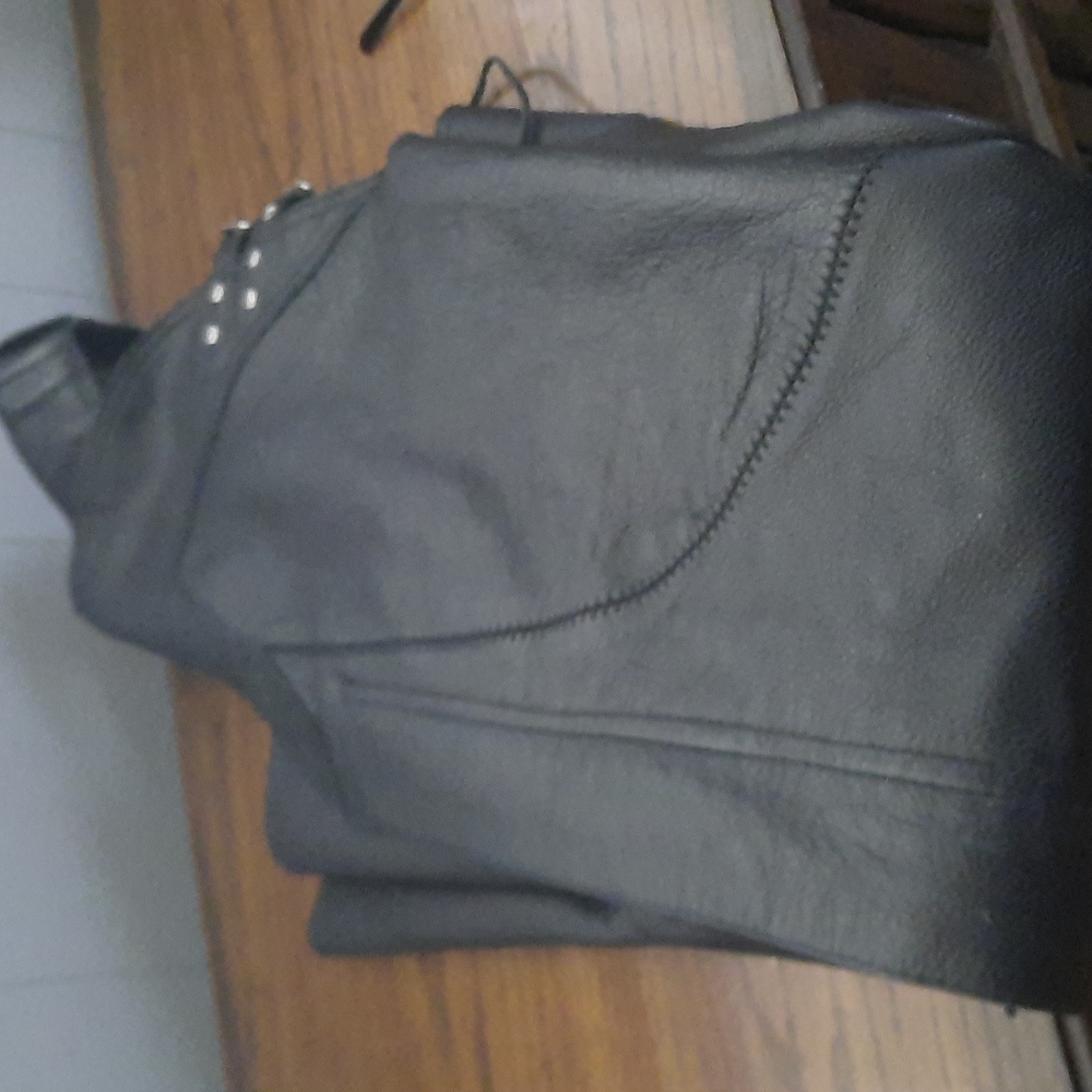 Women's riding black leather riding chaps.